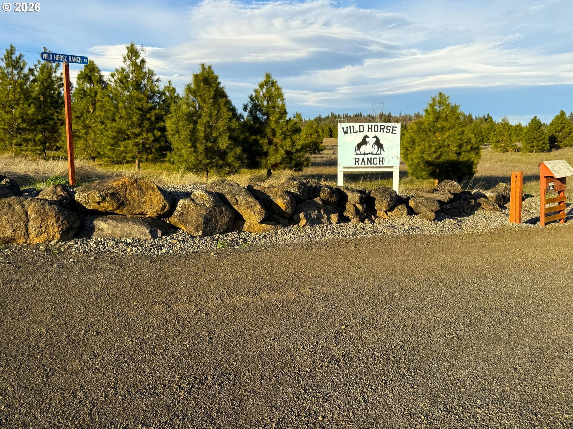 44 Wildhorse Ranch Road Goldendale, WA 98620 - Photo 28 of 42 a picture of a building with a lot of plants and trees