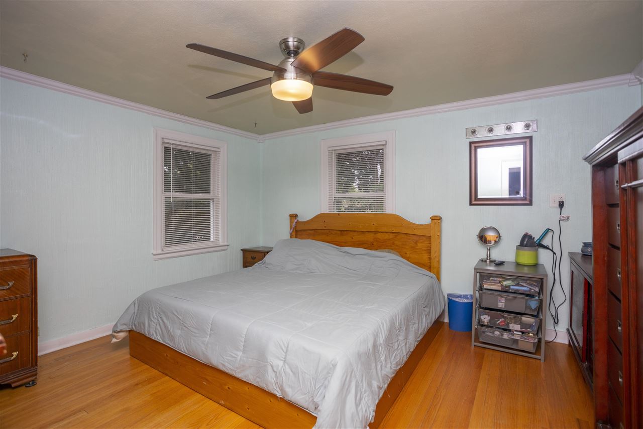 2128 North Alpine Road Rockford, IL 61107 - Photo 7 of 16 a bedroom with a bed and a chandelier