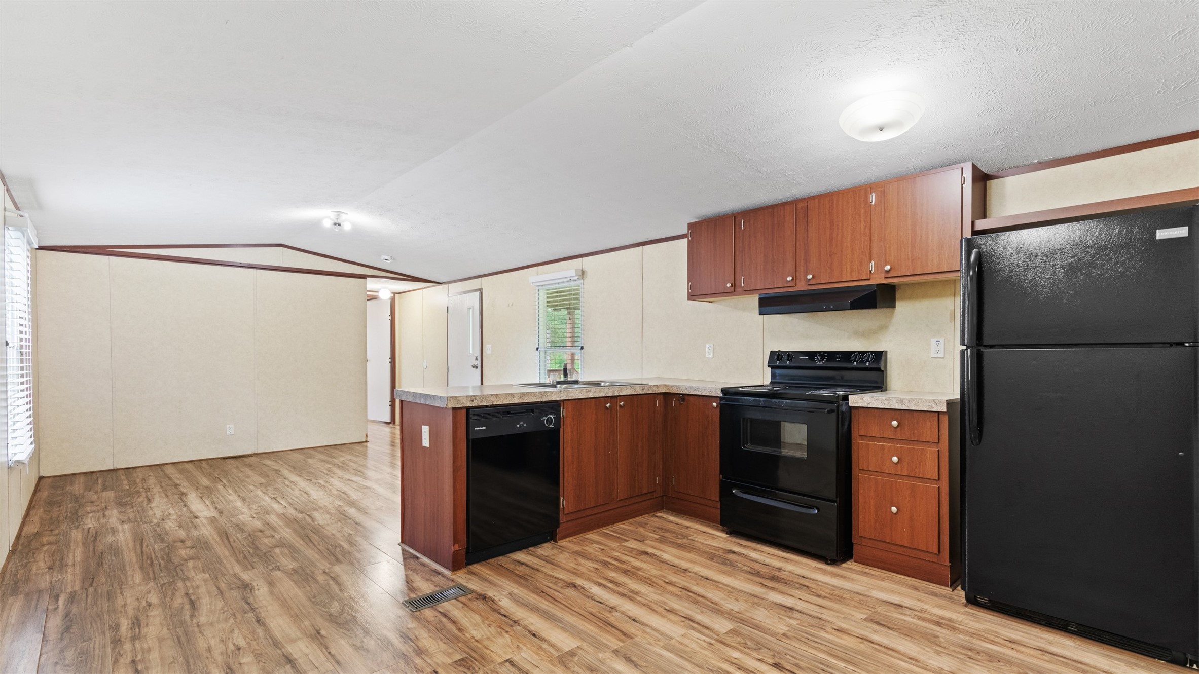 91 Maple Lane Shepherd, TX 77371 - Photo 4 of 15 a kitchen with stainless steel appliances granite countertop a refrigerator stove and sink