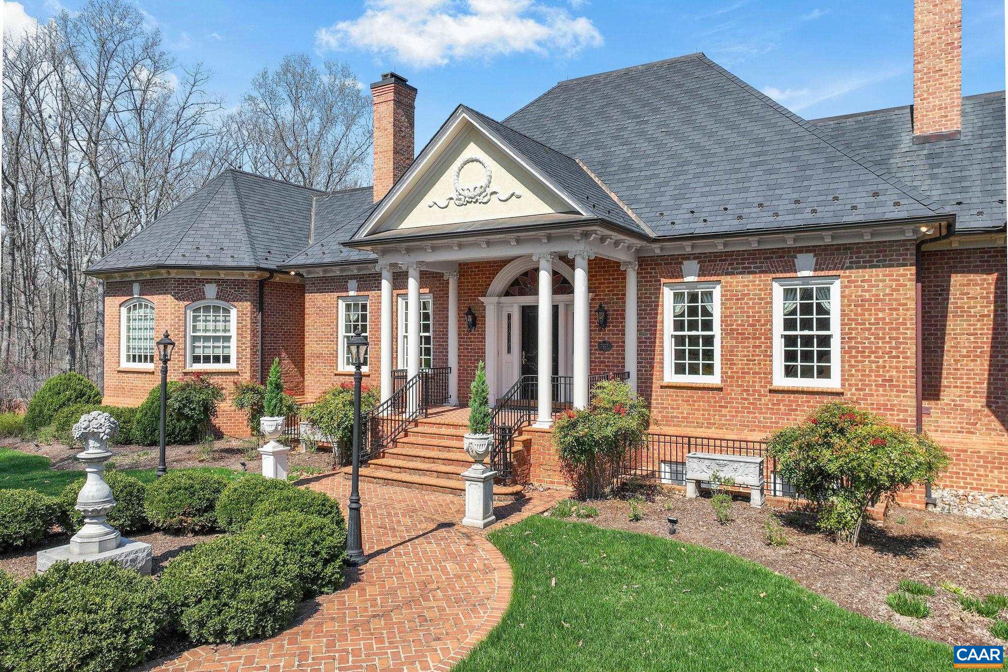 6385 Indian Ridge Drive Earlysville, VA 22936 - Photo 1 of 48 a front view of a house with garden