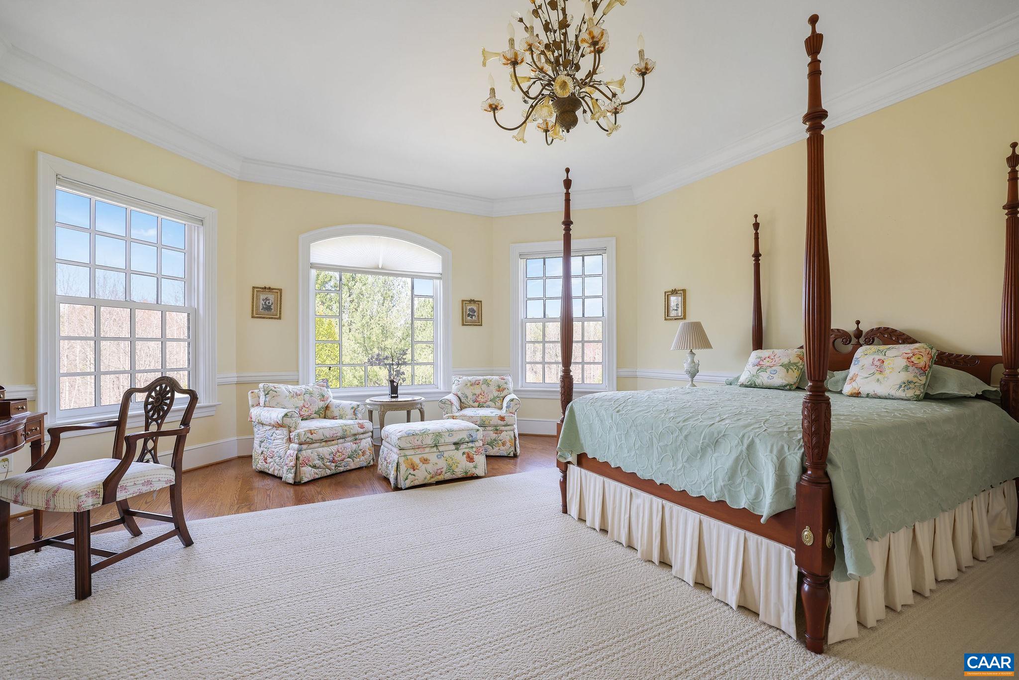 6385 Indian Ridge Drive Earlysville, VA 22936 - Photo 16 of 48 a bedroom with double bed windows and a chandelier
