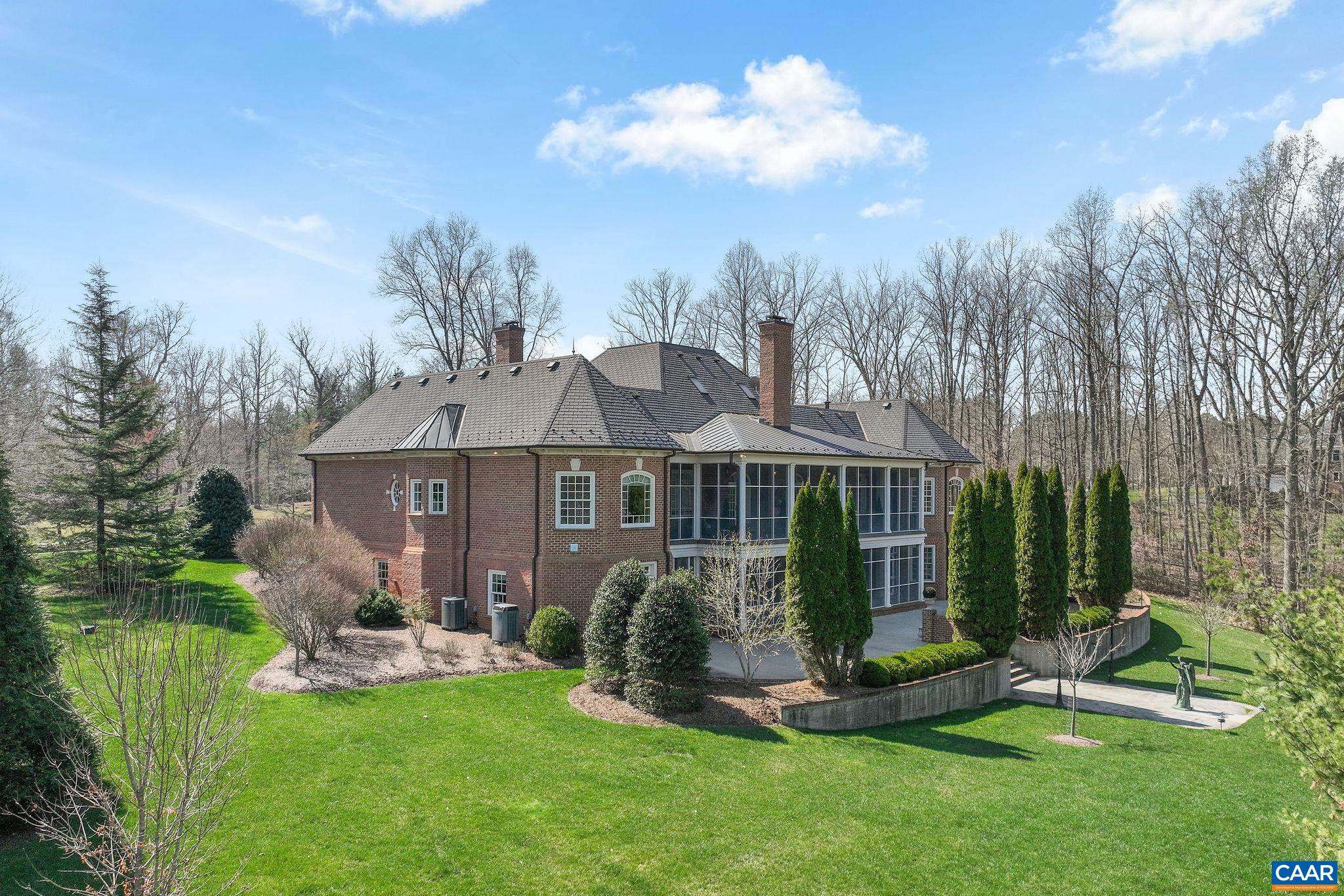 6385 Indian Ridge Drive Earlysville, VA 22936 - Photo 2 of 48 a front view of a house with a garden and plants