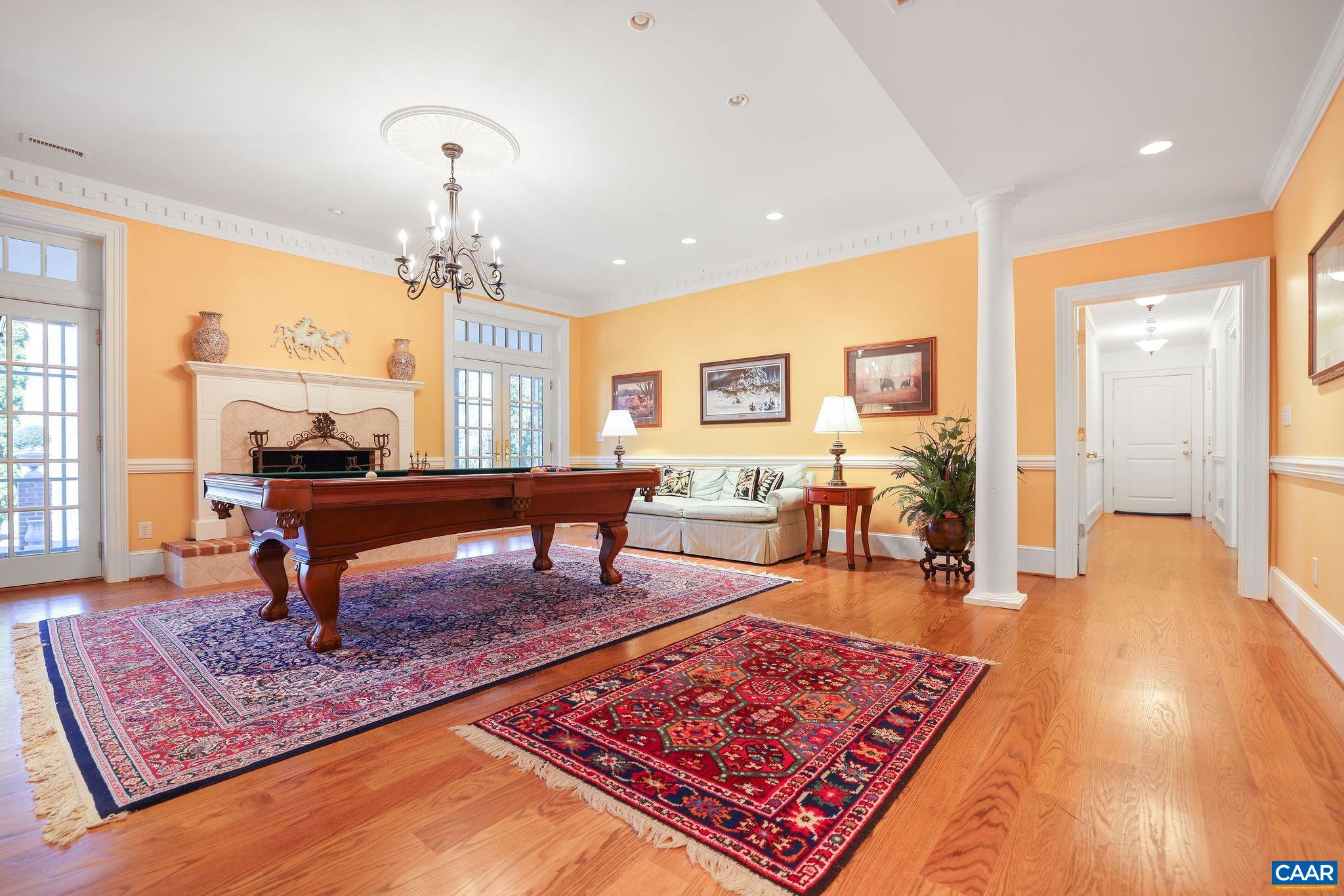 6385 Indian Ridge Drive Earlysville, VA 22936 - Photo 25 of 48 a living room with furniture a rug and a chandelier