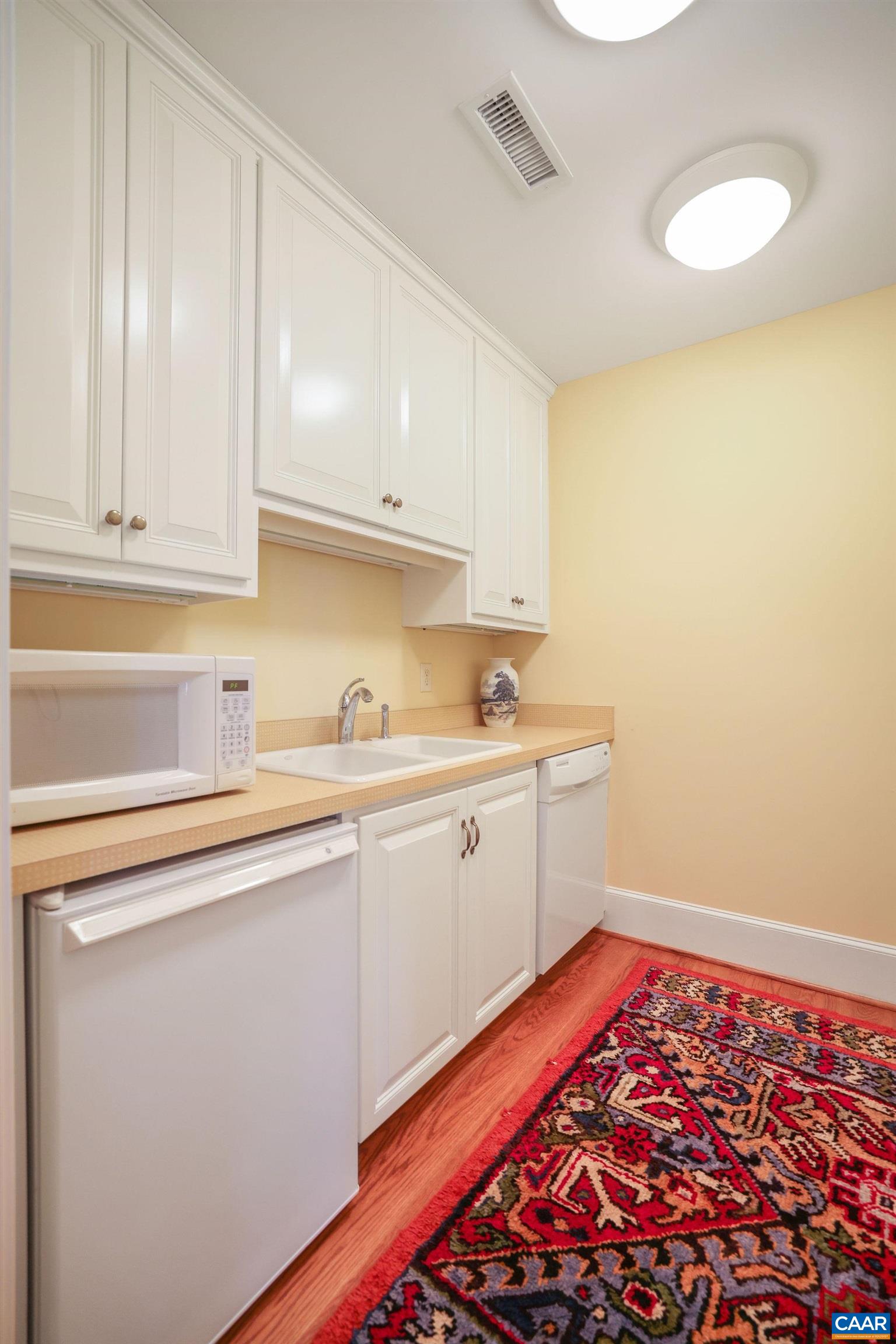 6385 Indian Ridge Drive Earlysville, VA 22936 - Photo 26 of 48 a kitchen with a sink and cabinets