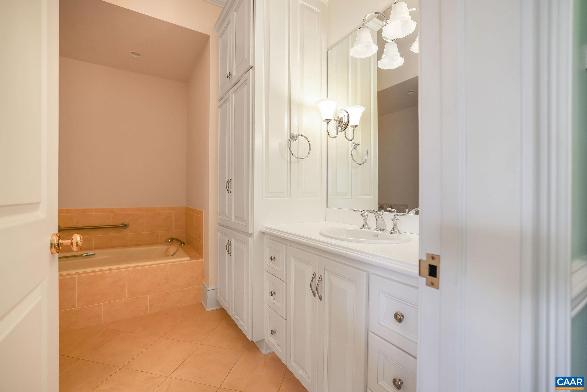 6385 Indian Ridge Drive Earlysville, VA 22936 - Photo 34 of 48 a bathroom with a granite countertop sink mirror and a bathtub