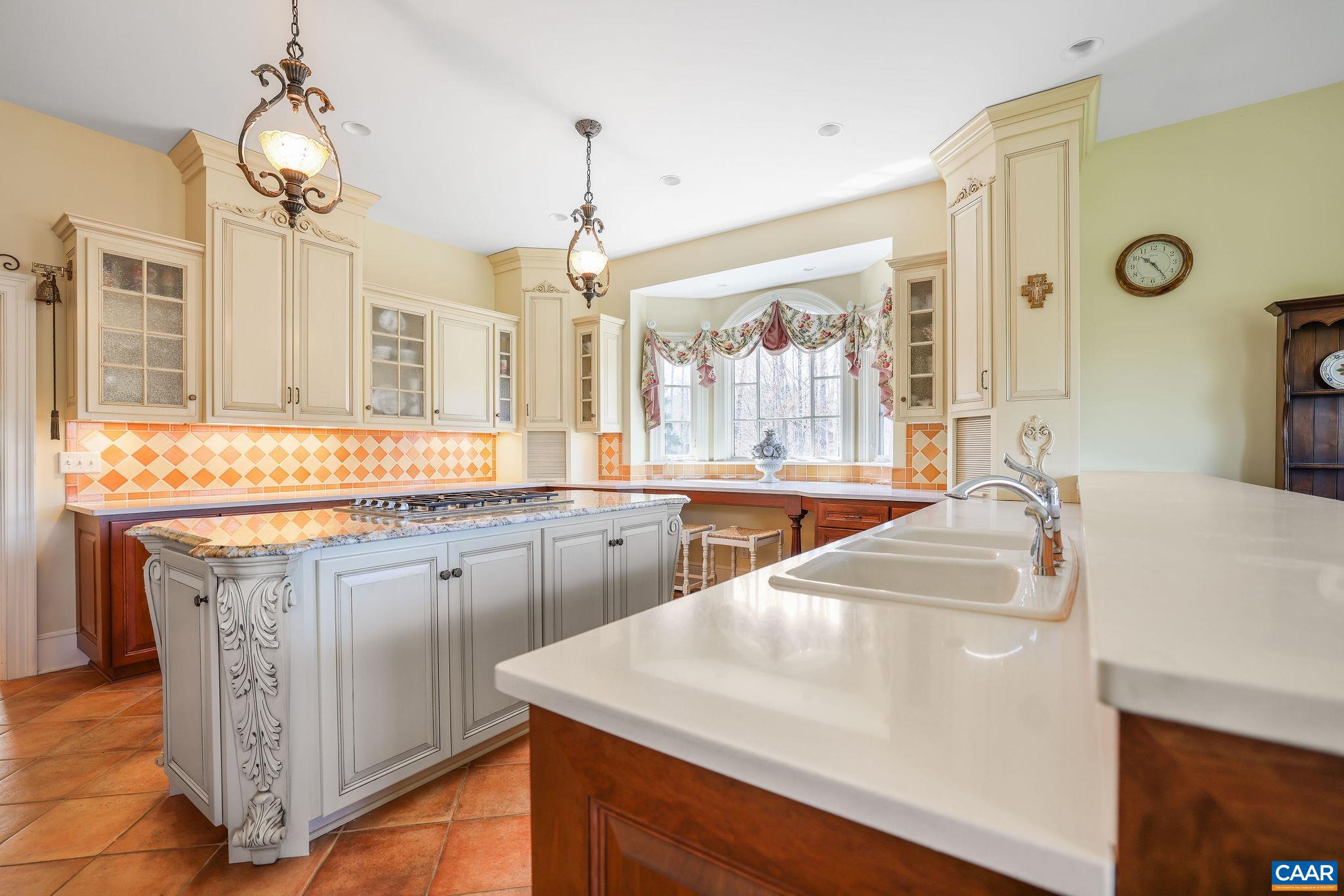 6385 Indian Ridge Drive Earlysville, VA 22936 - Photo 9 of 48 a kitchen with stainless steel appliances granite countertop a sink dishwasher and white cabinets with wooden floor