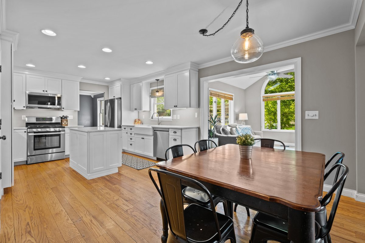 2115 Forest Ridge Road St. Charles, IL 60174 - Photo 11 of 25 a kitchen with a dining table chairs stainless steel appliances and windows