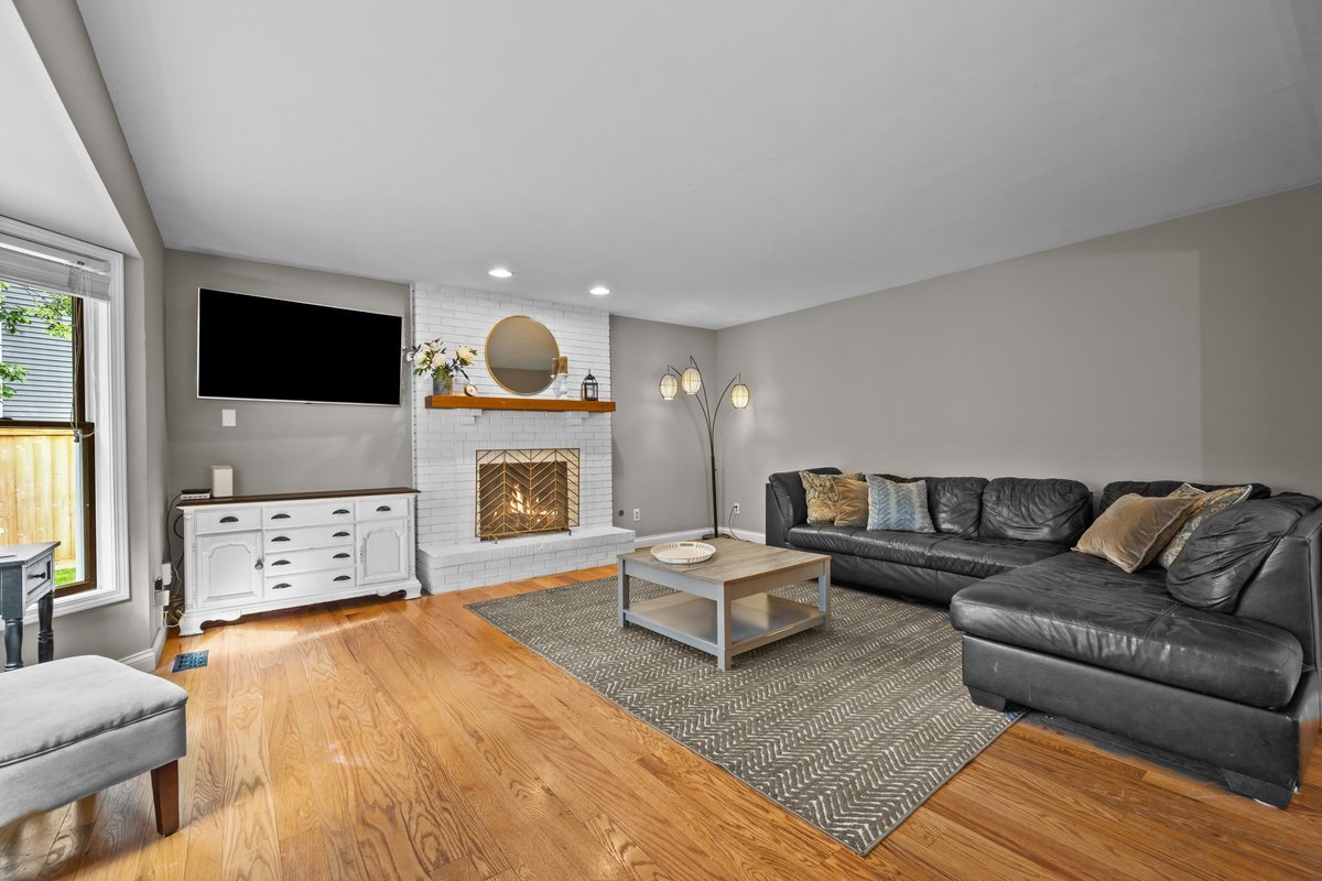 2115 Forest Ridge Road St. Charles, IL 60174 - Photo 12 of 25 a living room with furniture a fireplace and a flat screen tv