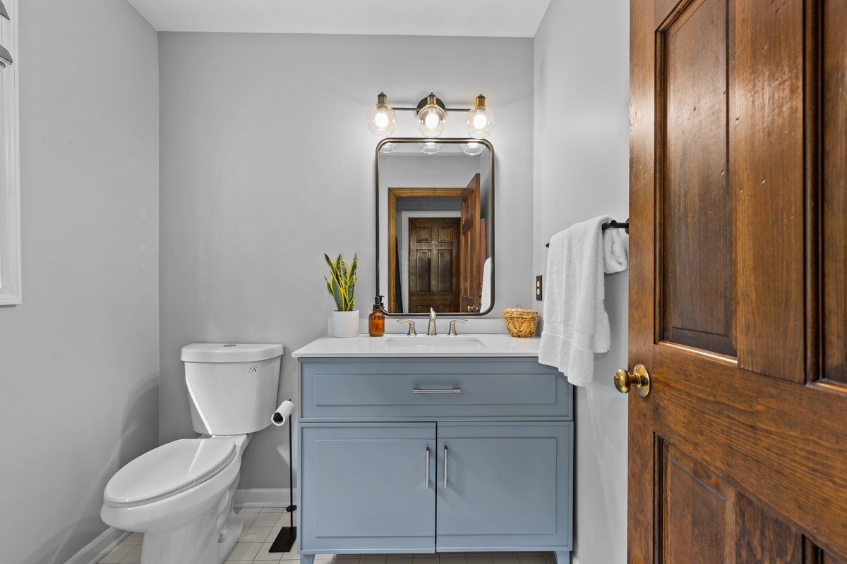 2115 Forest Ridge Road St. Charles, IL 60174 - Photo 17 of 25 a bathroom with a toilet sink and mirror