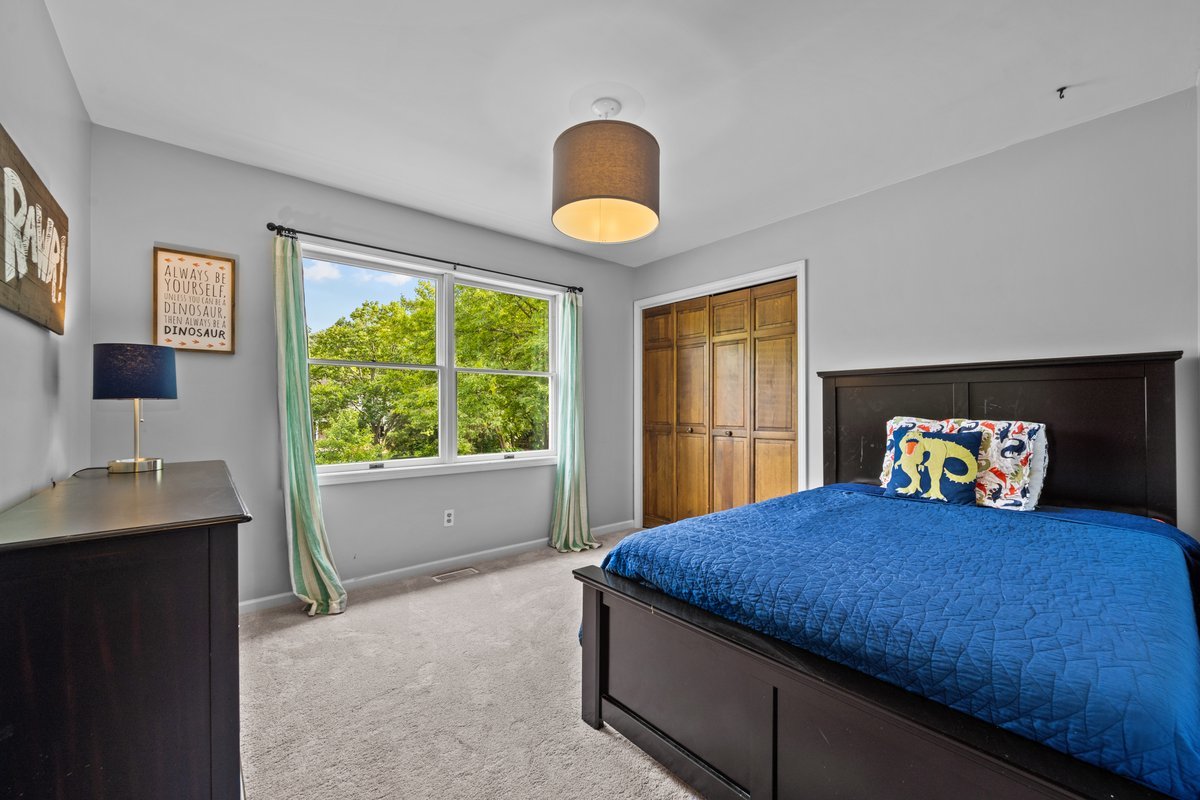 2115 Forest Ridge Road St. Charles, IL 60174 - Photo 19 of 25 a bedroom with a bed and a large window