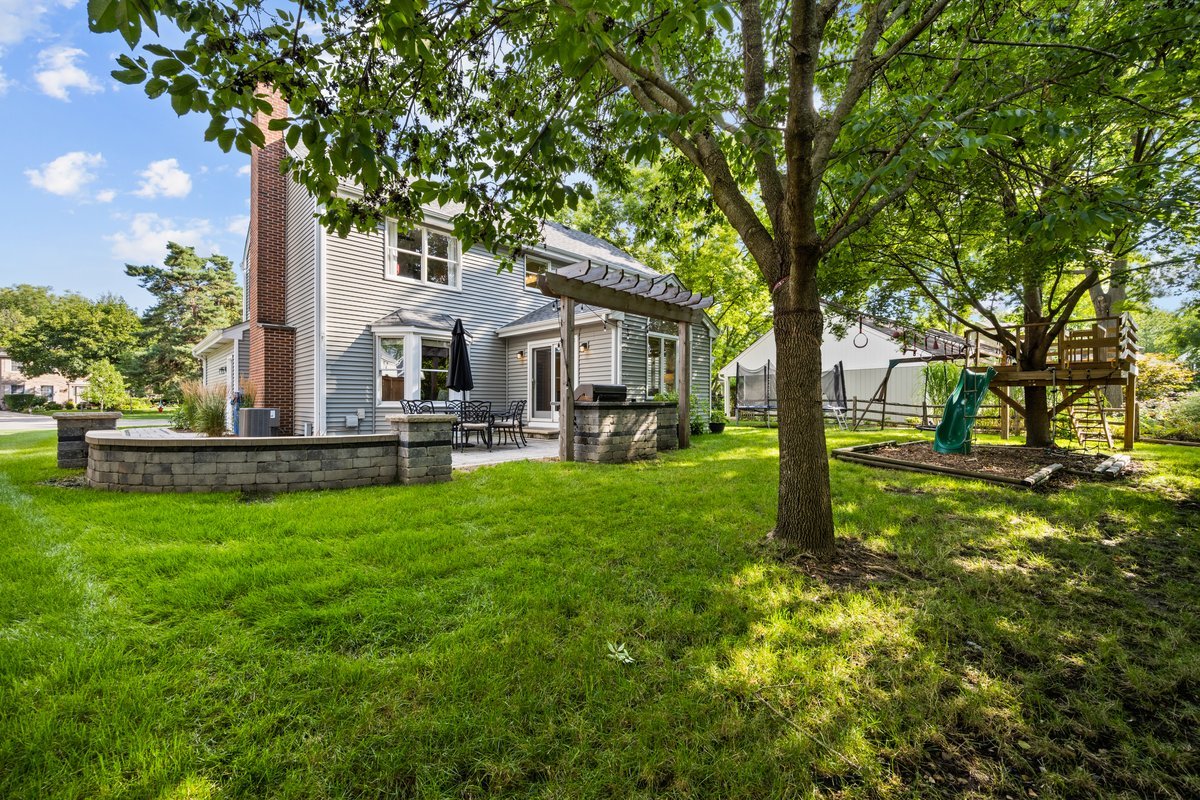 2115 Forest Ridge Road St. Charles, IL 60174 - Photo 25 of 25 a front view of a house with swimming pool and green space