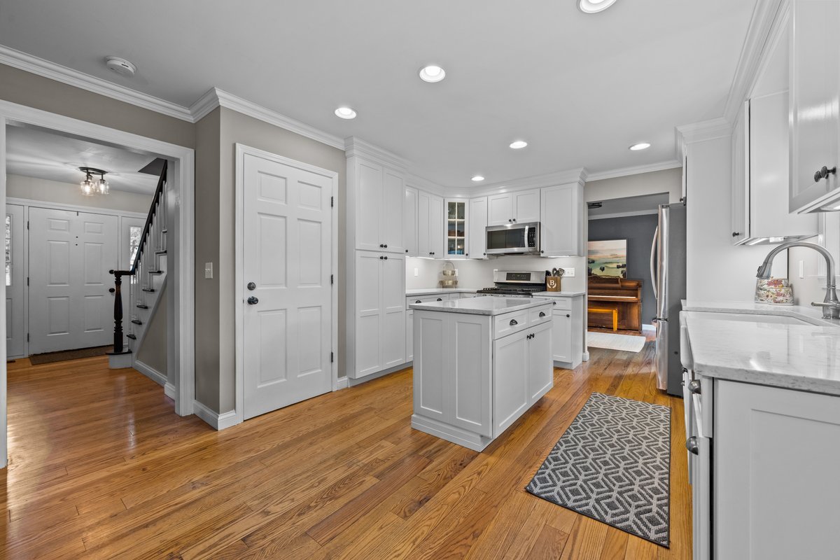 2115 Forest Ridge Road St. Charles, IL 60174 - Photo 7 of 25 a kitchen with white cabinets and stainless steel appliances