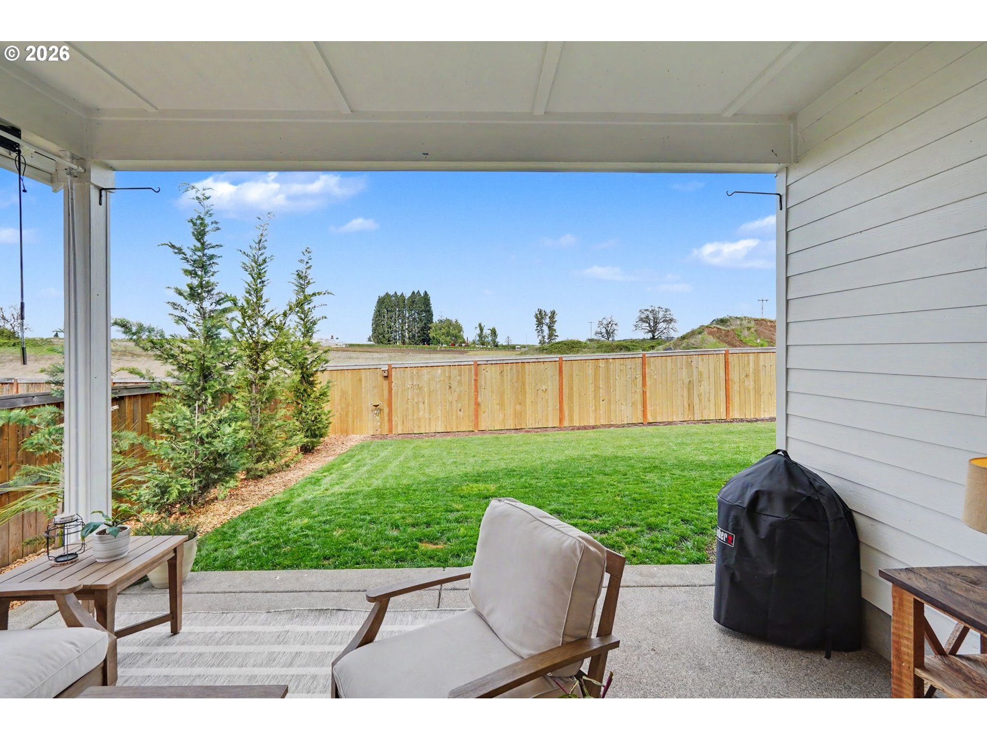 835 Reagan Street Mount Angel, OR 97362 - Photo 39 of 45 a view of a backyard with couches plants and large tree