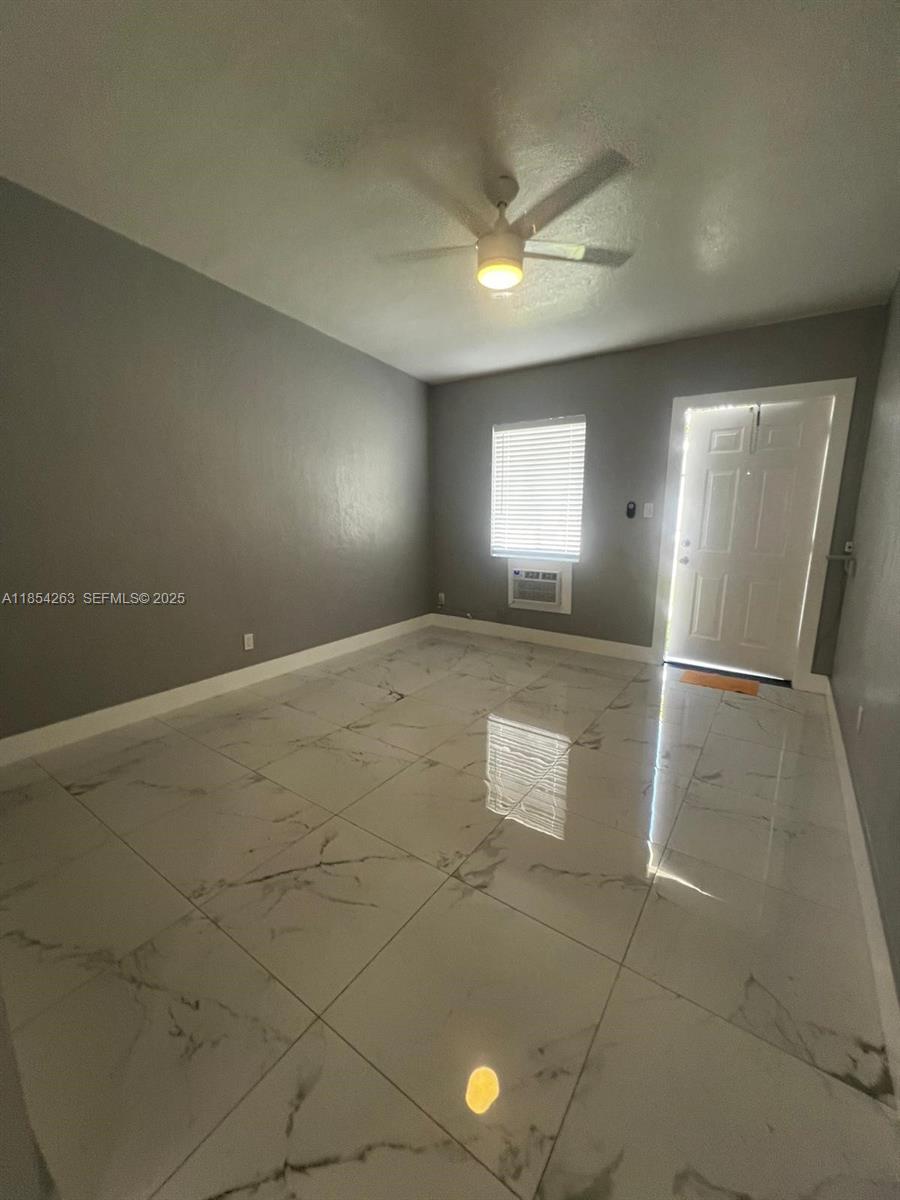 2090 Northwest 31st Street, Unit 2 Miami, FL 33142 - Photo 4 of 10 an empty room with windows and entrance
