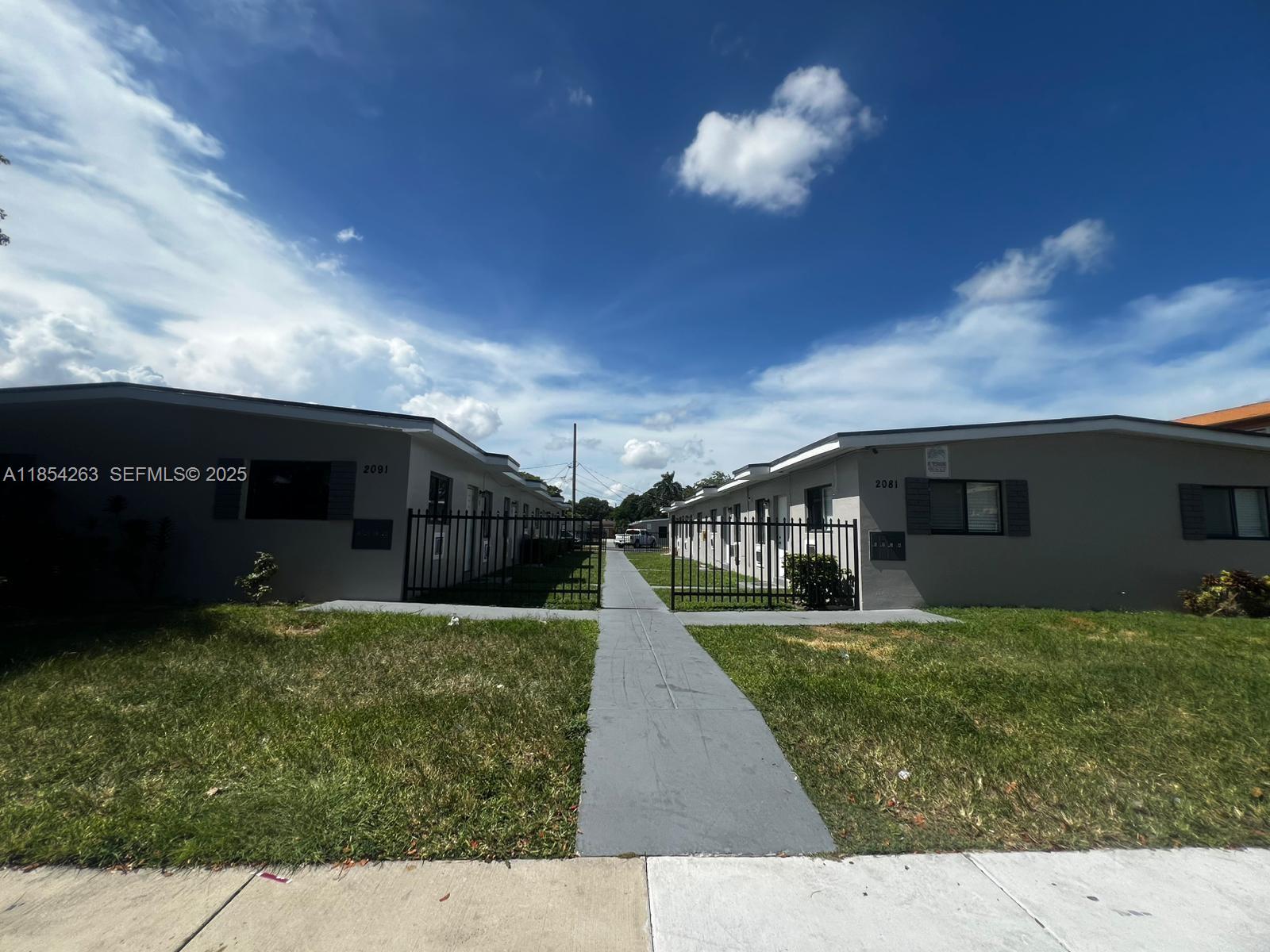 2090 Northwest 31st Street, Unit 2 Miami, FL 33142 - Photo 8 of 10 a view of a yard in front of a house