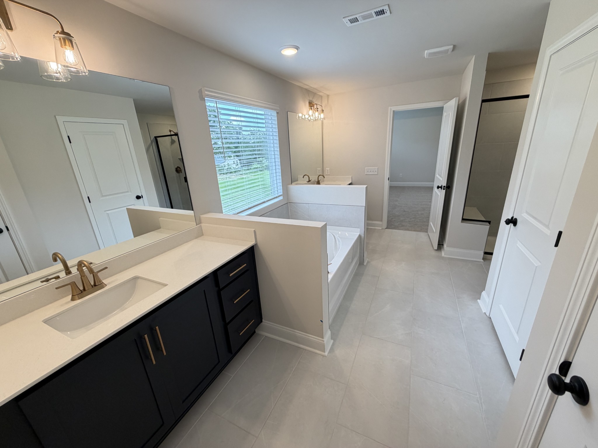 147 Emeline Way Mount Juliet, TN 37122 - Photo 40 of 41 a bathroom with a sink a tub and a mirror
