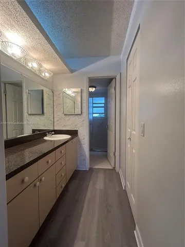 a large bathroom with a sink and a large mirror