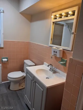 a bathroom with a sink toilet and mirror