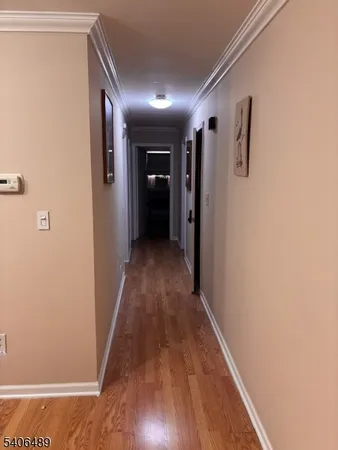 a view of hallway with wooden floor