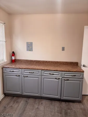 a view of a kitchen with cabinets and wooden floor