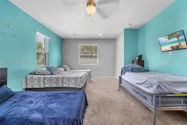 a bedroom with a large bed and a chandelier