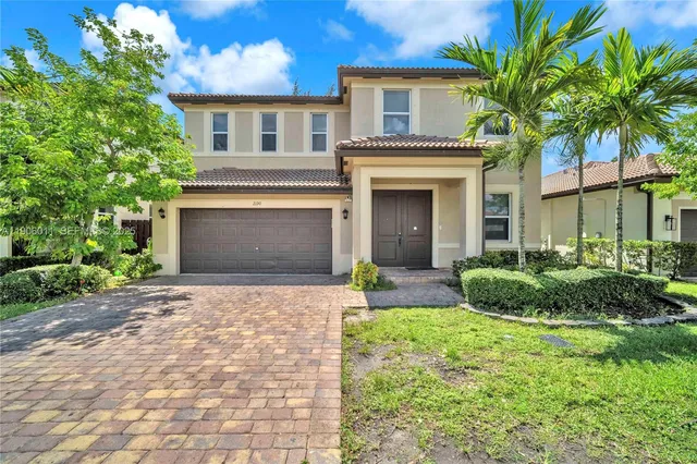 a front view of a house with a yard and garage