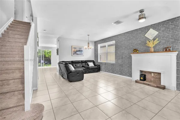 a spacious bedroom with a bed a fireplace and window