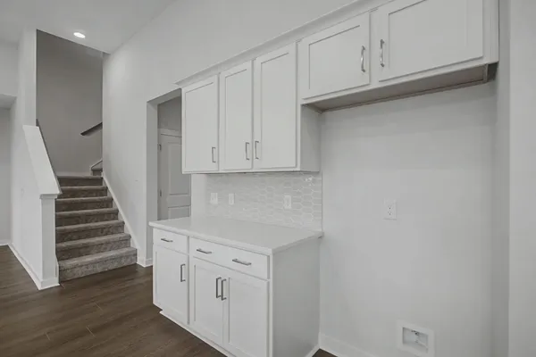 a kitchen with a sink and chandelier