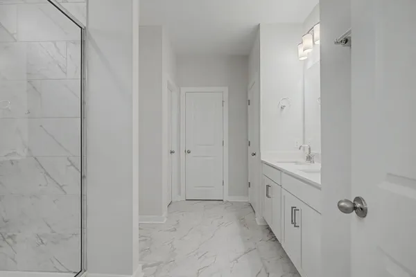 a spacious bathroom with a double vanity sink a mirror and a