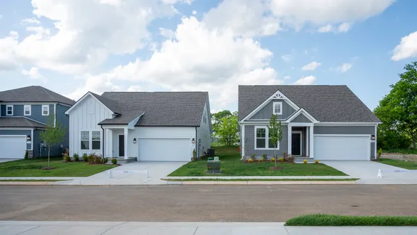 a view of house with outdoor space and trees