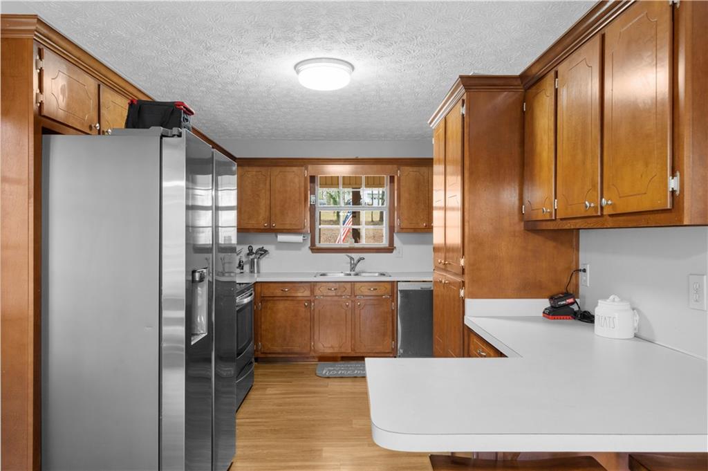 6124 Clyde Conner Road Murrayville, GA 30564 - Photo 12 of 48 a large kitchen with stainless steel appliances granite countertop a granite counter tops and a view of kitchen