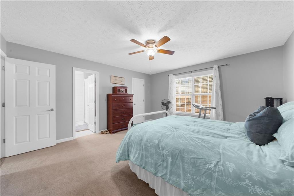 6124 Clyde Conner Road Murrayville, GA 30564 - Photo 19 of 48 a bedroom with a bed and a large window