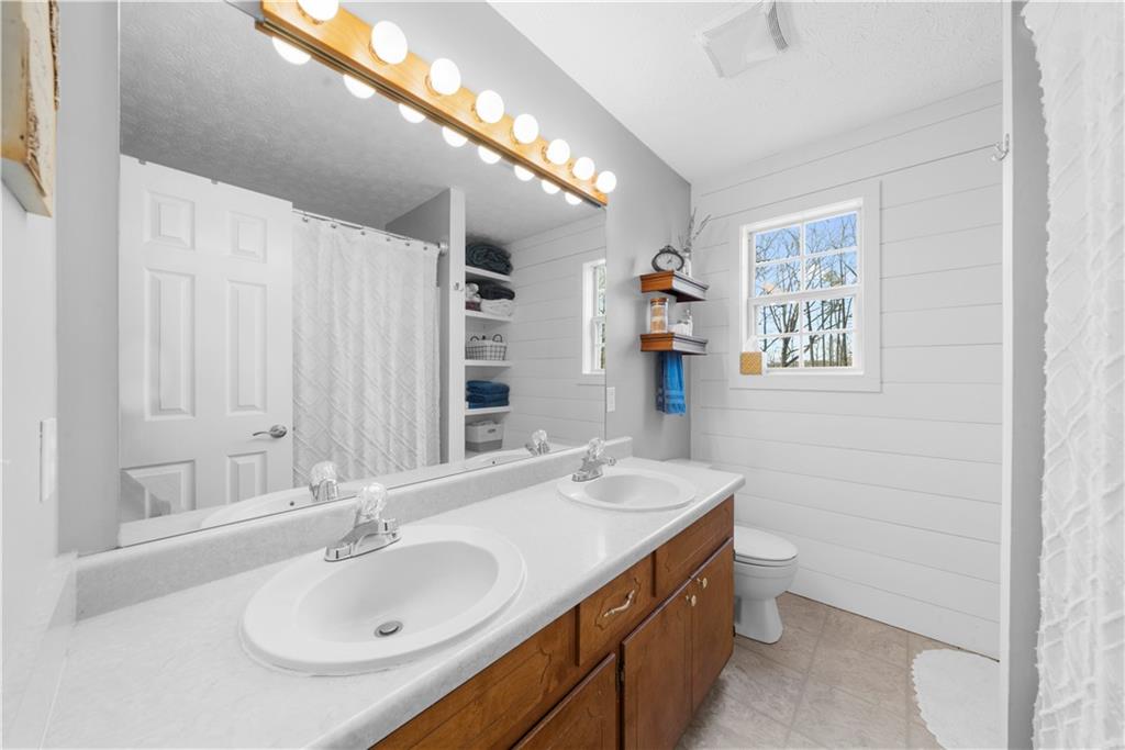 6124 Clyde Conner Road Murrayville, GA 30564 - Photo 20 of 48 a bathroom with a sink double vanity and a mirror