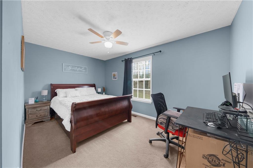 6124 Clyde Conner Road Murrayville, GA 30564 - Photo 23 of 48 a bedroom with a bed gym equipment and a window