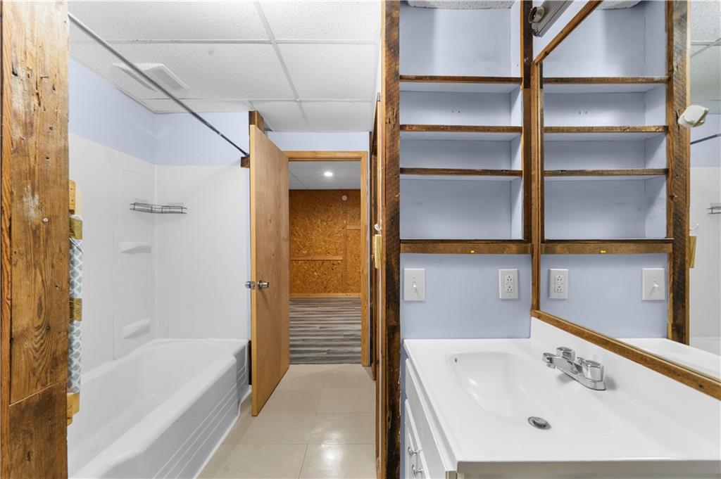 6124 Clyde Conner Road Murrayville, GA 30564 - Photo 31 of 48 a bathroom with a tub and a sink