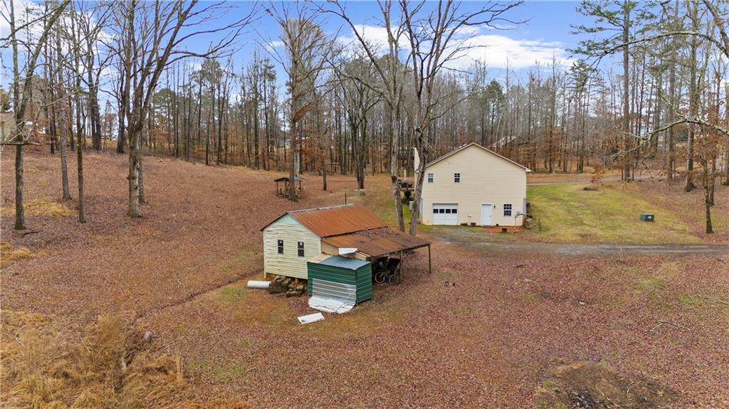 6124 Clyde Conner Road Murrayville, GA 30564 - Photo 36 of 48 a small house with trees in front of it