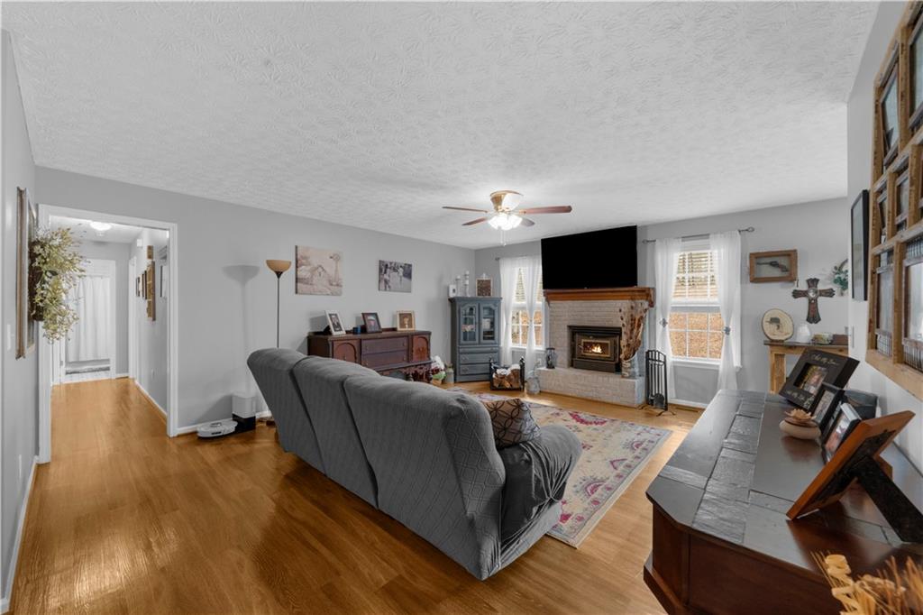 6124 Clyde Conner Road Murrayville, GA 30564 - Photo 4 of 48 a living room with furniture a fireplace and a flat screen tv