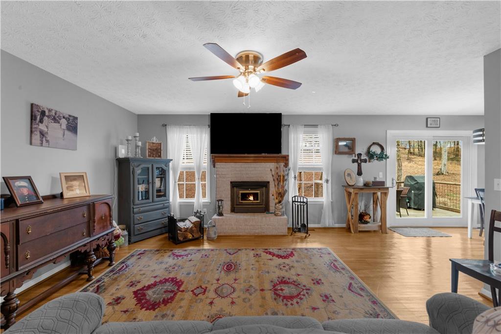 6124 Clyde Conner Road Murrayville, GA 30564 - Photo 5 of 48 a living room with furniture a fireplace and a flat screen tv