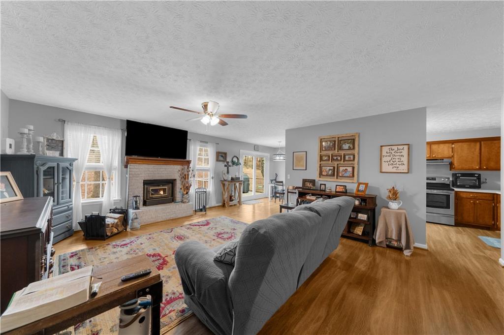 6124 Clyde Conner Road Murrayville, GA 30564 - Photo 6 of 48 a living room with furniture a fireplace and a flat screen tv