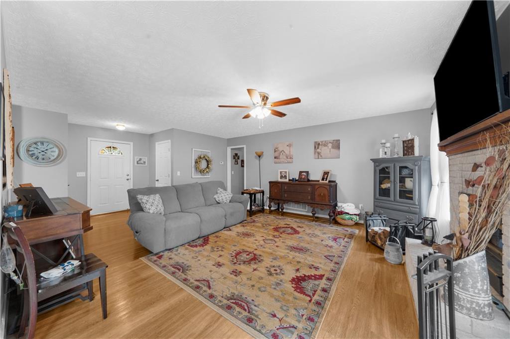 6124 Clyde Conner Road Murrayville, GA 30564 - Photo 7 of 48 a living room with furniture flat screen tv and a fireplace