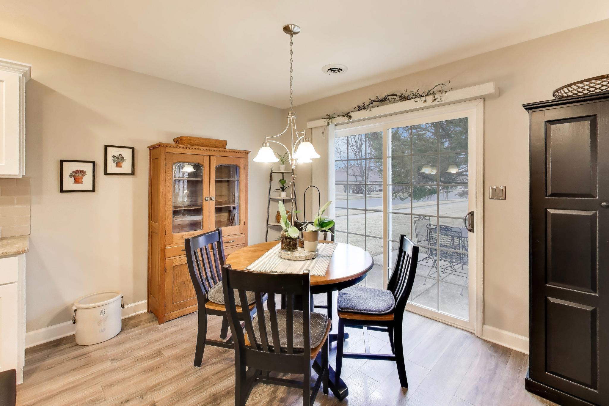 900 A Easy Street Crown Point, IN 46307 - Photo 11 of 22 a dining room with furniture a chandelier and wooden floor