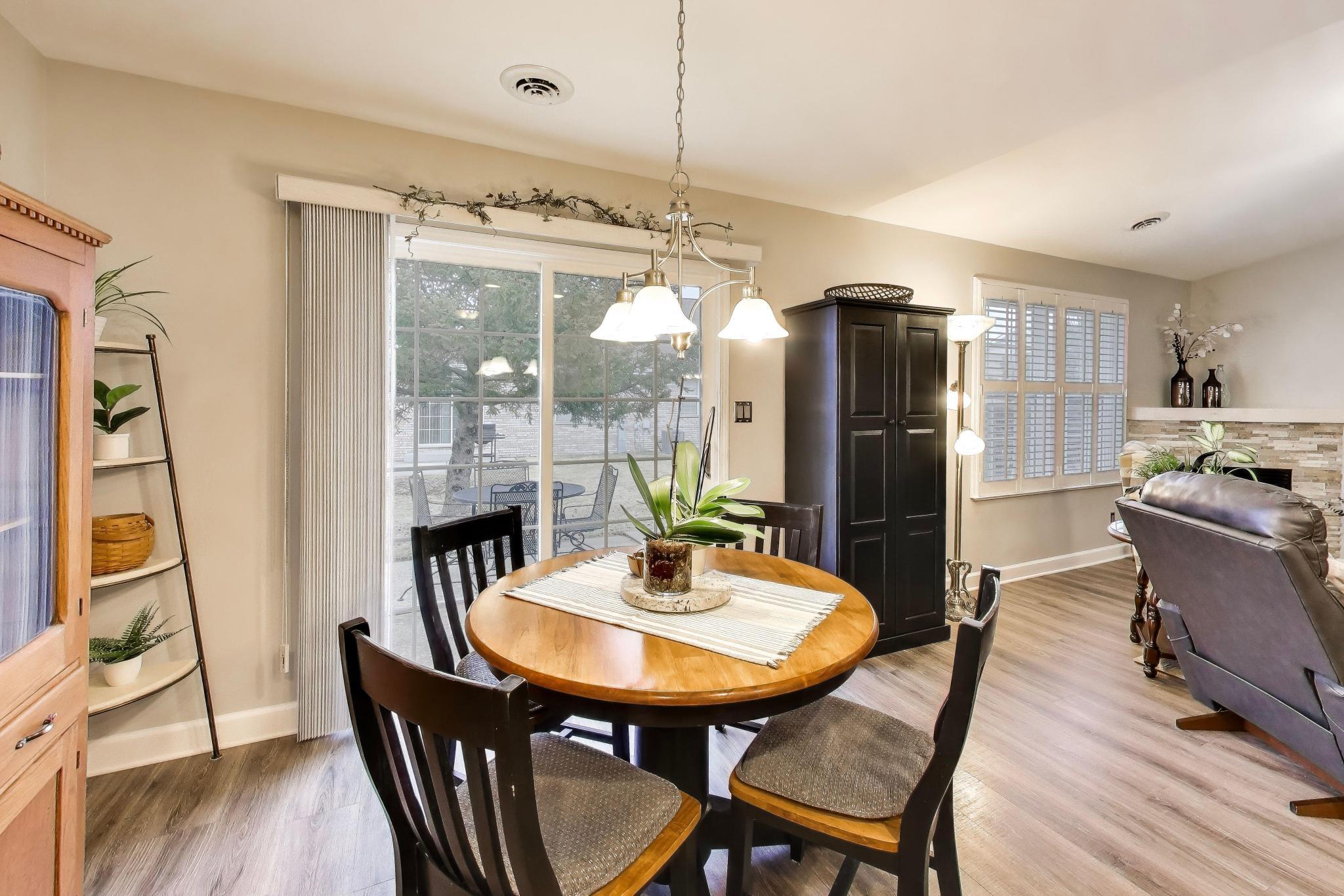 900 A Easy Street Crown Point, IN 46307 - Photo 13 of 22 a dining room with furniture a chandelier and wooden floor