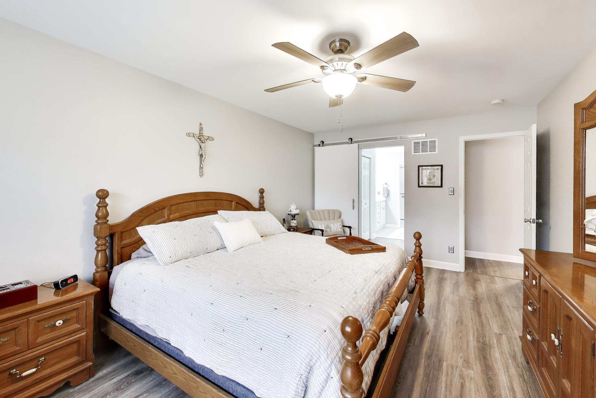 900 A Easy Street Crown Point, IN 46307 - Photo 16 of 22 a bedroom with a bed and a chandelier