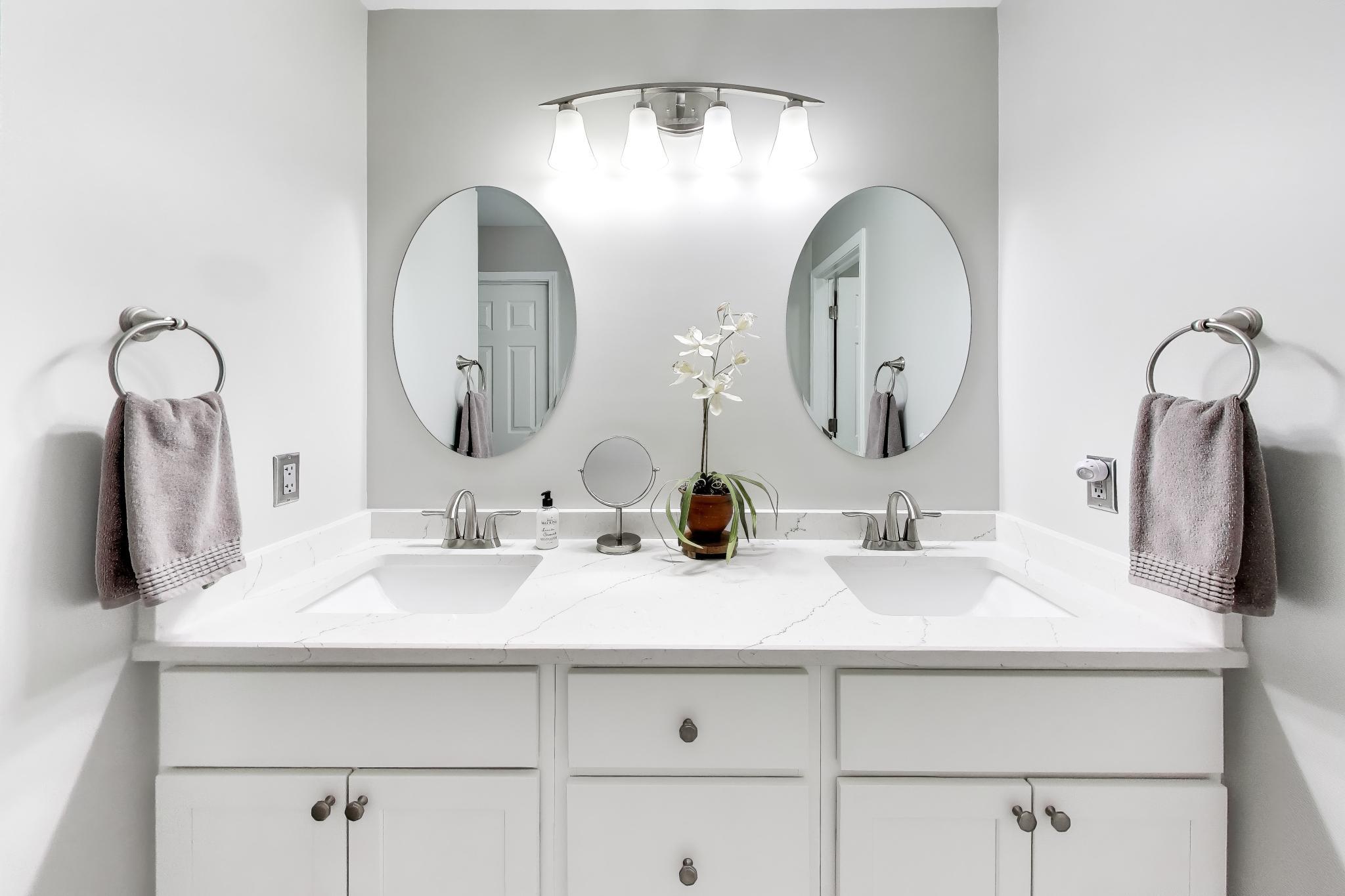 900 A Easy Street Crown Point, IN 46307 - Photo 17 of 22 a bathroom with double vanity sinks and a mirror