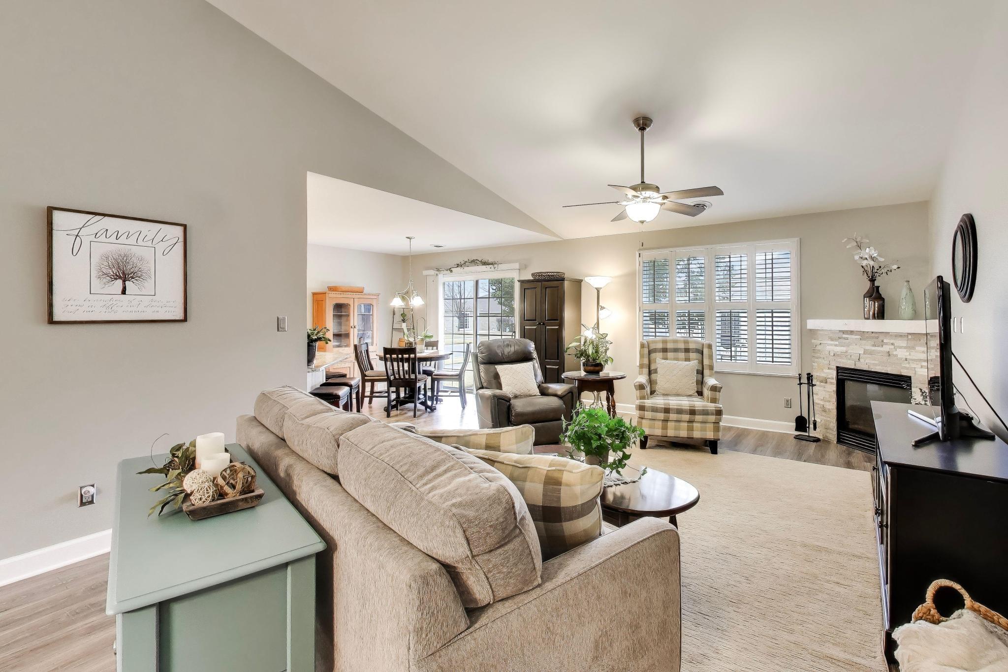 900 A Easy Street Crown Point, IN 46307 - Photo 3 of 22 a living room with furniture a fireplace and a chandelier