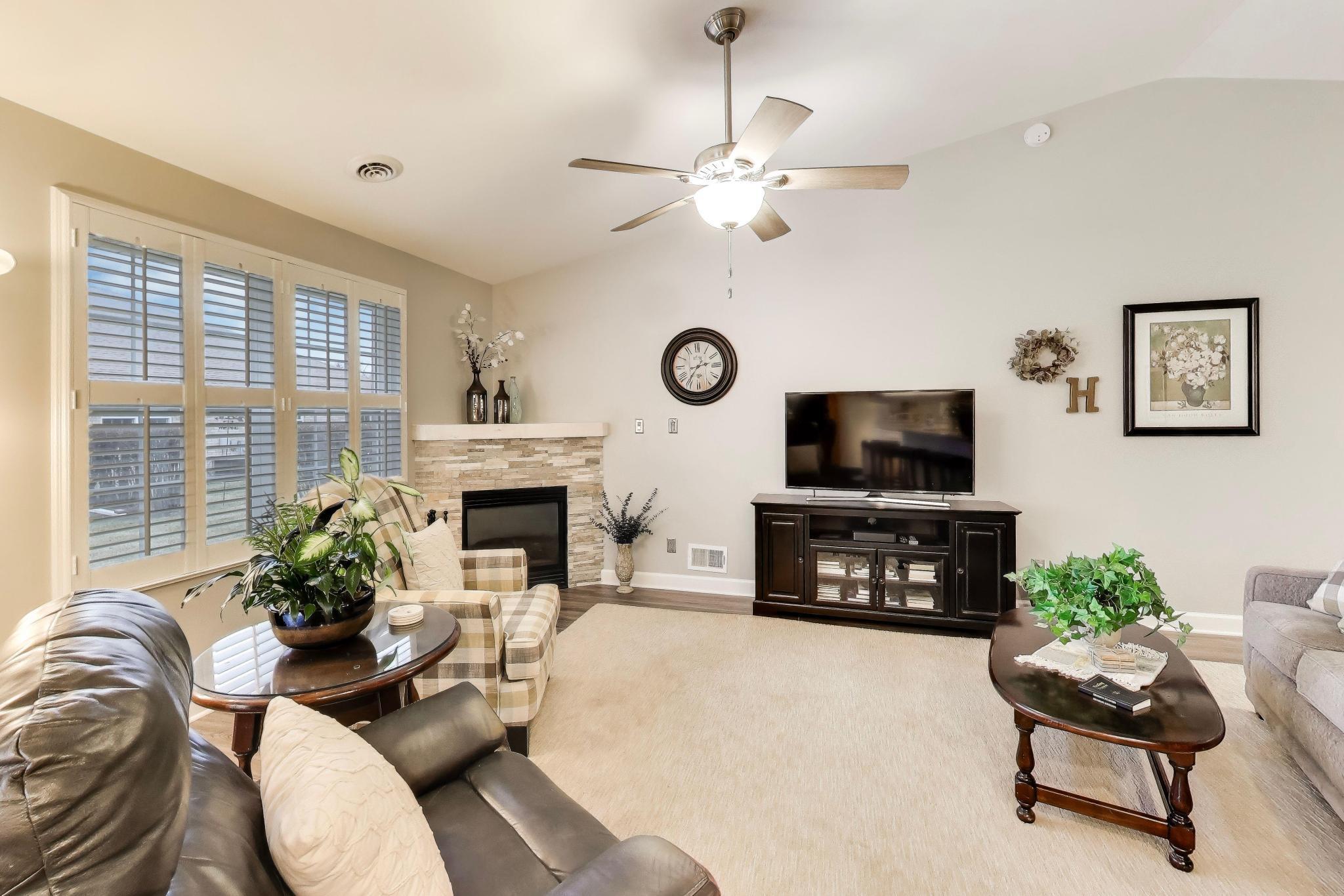 900 A Easy Street Crown Point, IN 46307 - Photo 5 of 22 a living room with furniture a fireplace and a flat screen tv