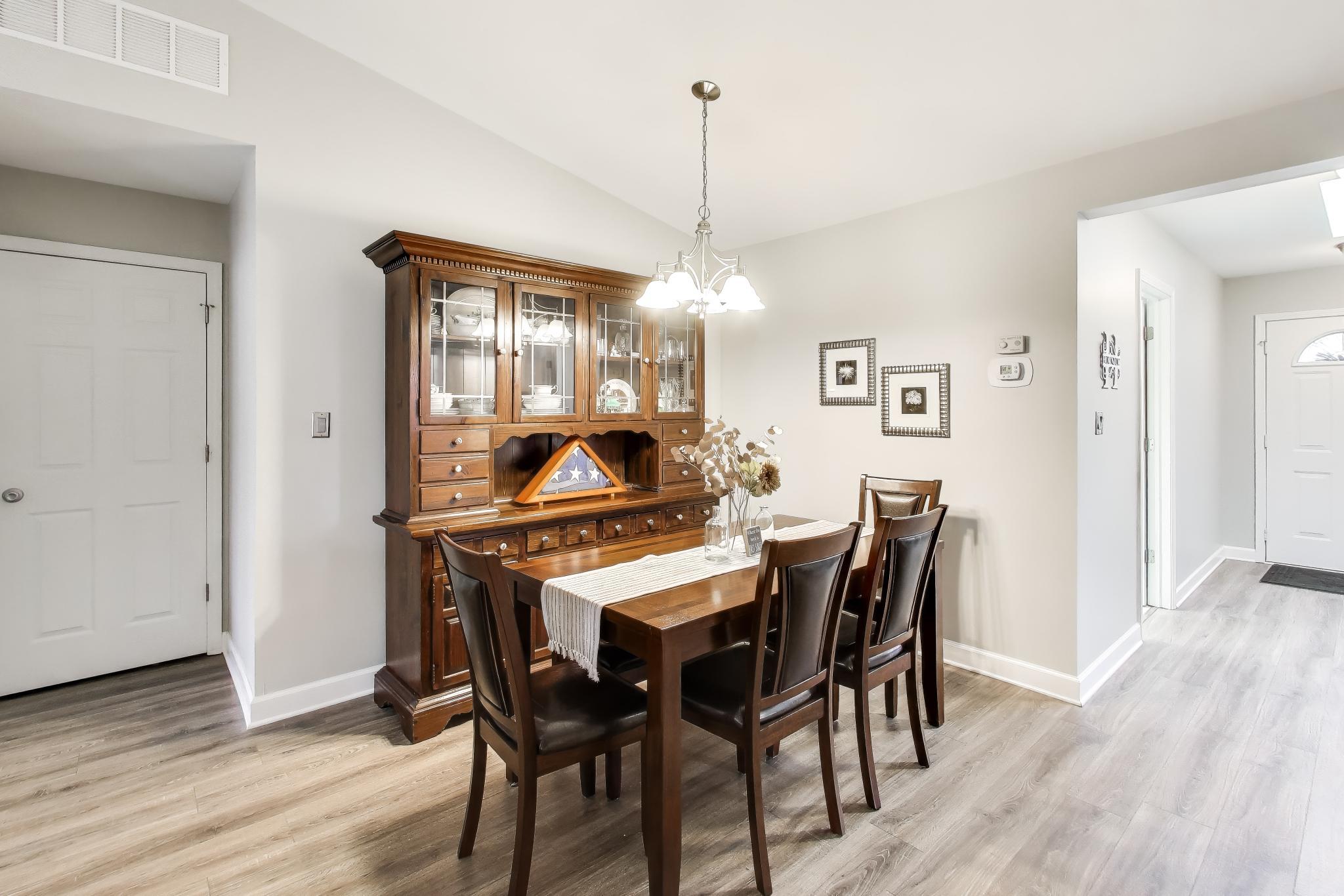 900 A Easy Street Crown Point, IN 46307 - Photo 6 of 22 a dining room with a wooden table and chairs