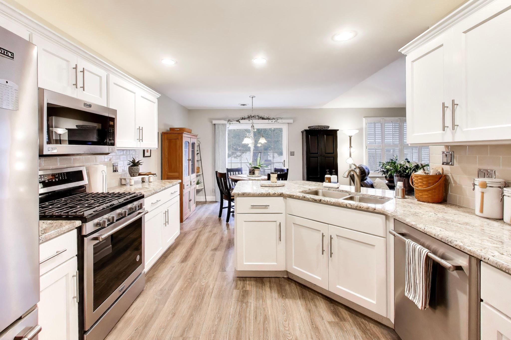 900 A Easy Street Crown Point, IN 46307 - Photo 8 of 22 a kitchen with white cabinets stainless steel appliances and sink