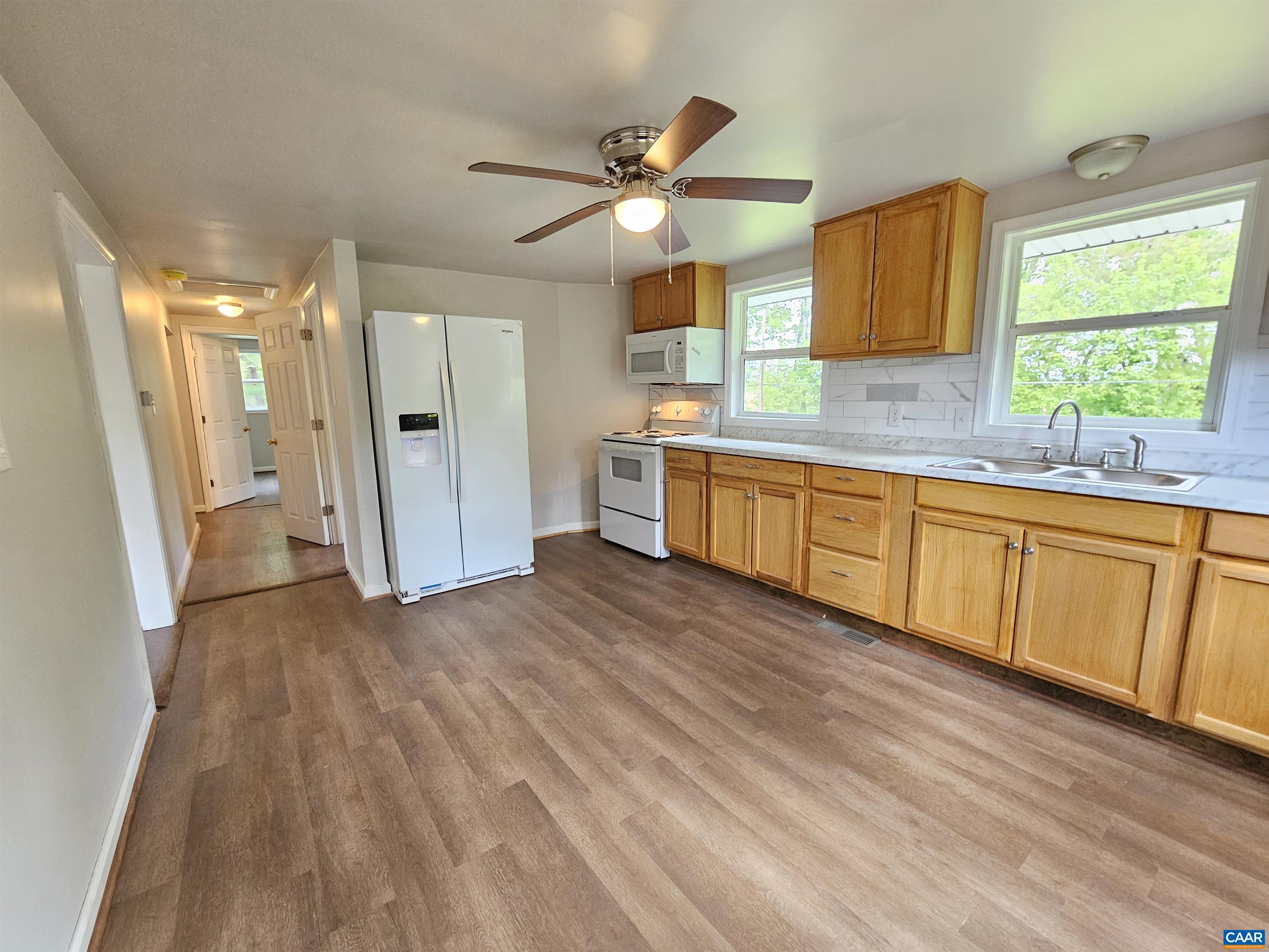 5290 Dixie Hill Road Buckingham, VA 23921 - Photo 11 of 24 a large kitchen with wooden floors and stainless steel appliances