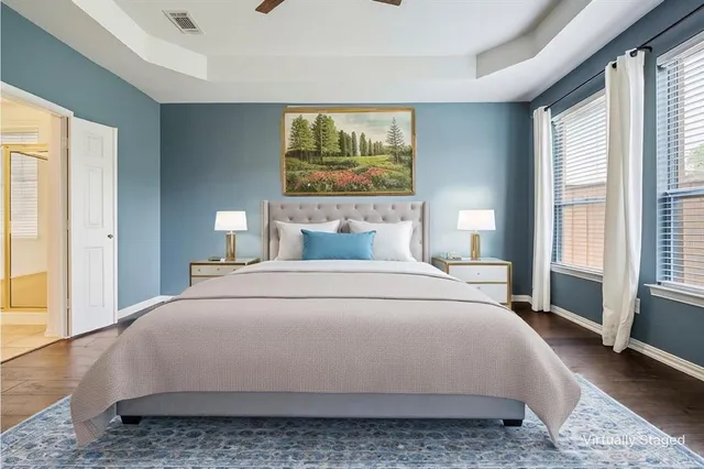 a bedroom with a large bed and a window